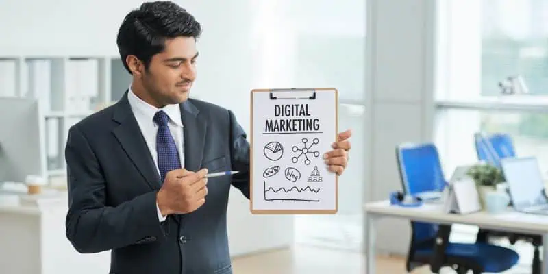 a man in suit holding a paper with text digital marketing